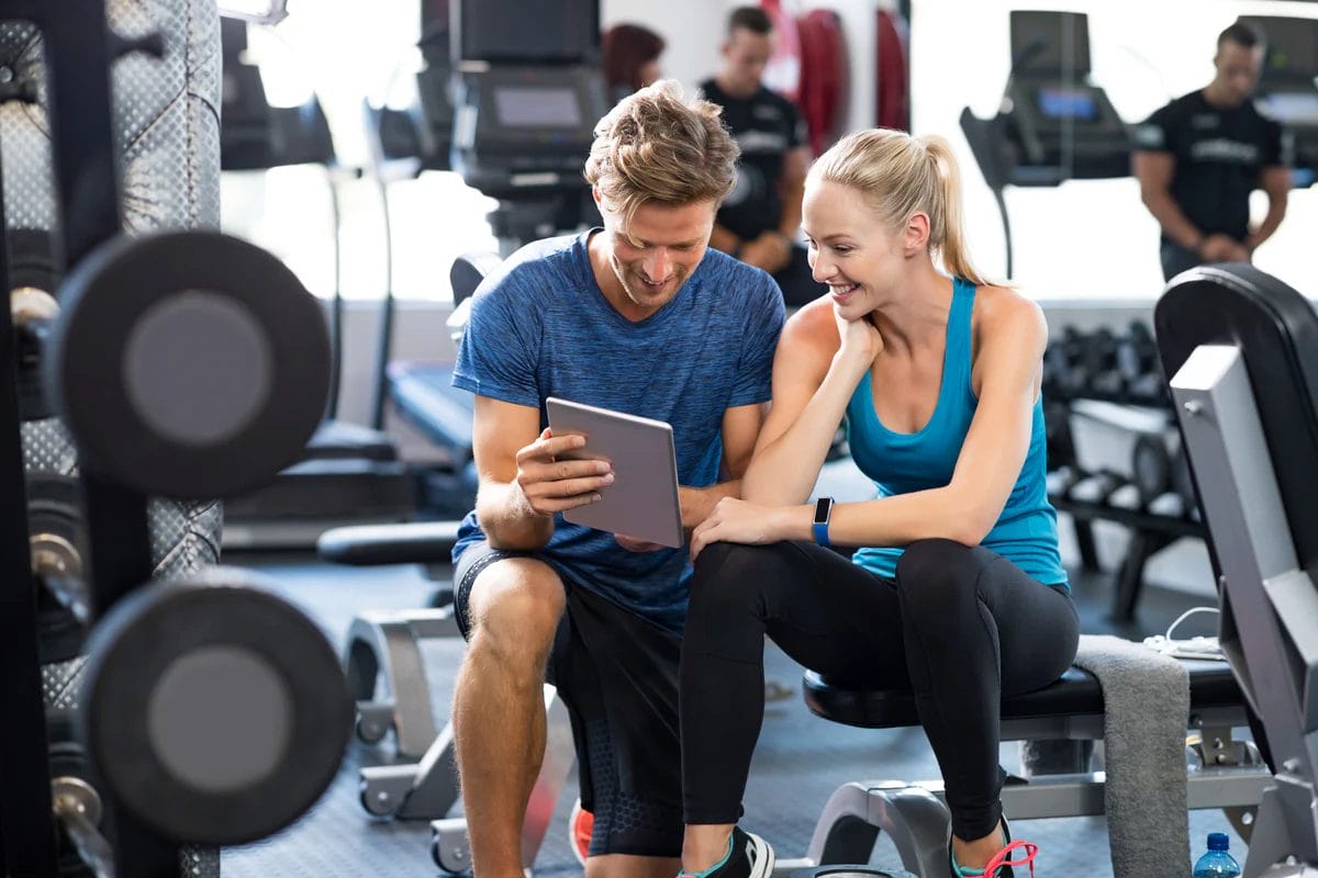 Why Your Workouts Need a Plan (Not Just Good Intentions) 1 trainer helping client with fitness
